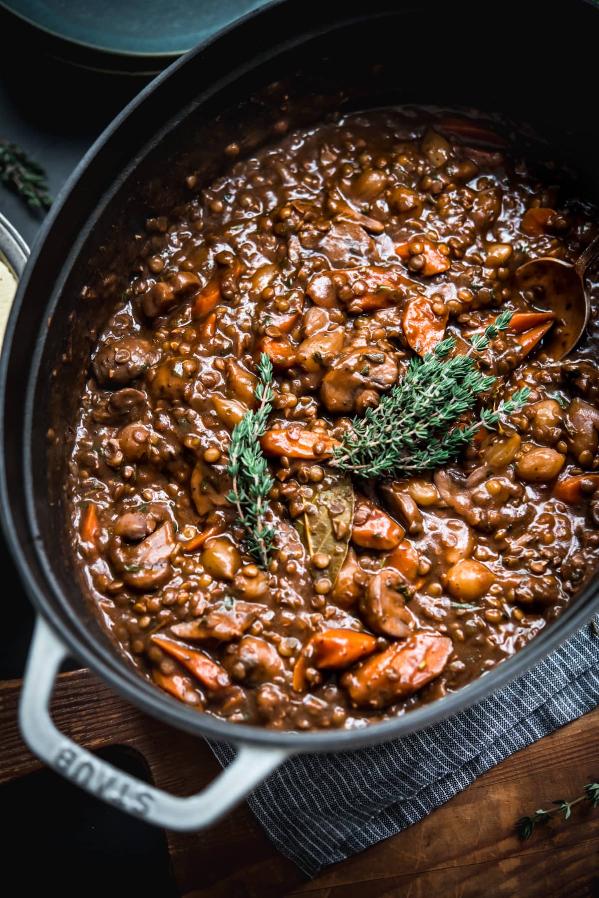 close up view of vegan lentil and mushrooom coq au vin in a large dutch oven.