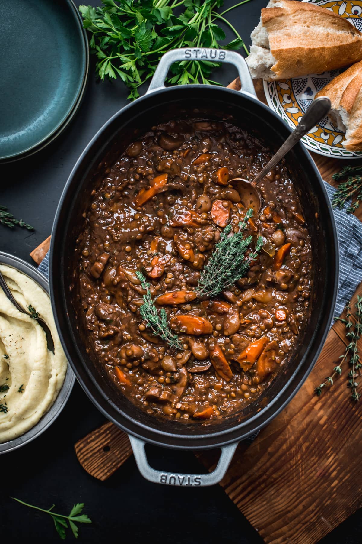 overhead view of vegan lentil and mushrooom coq au vin in a large dutch oven.