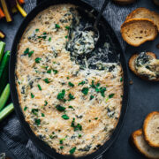 overhead view of vegan spinach artichoke dip in a skillet.