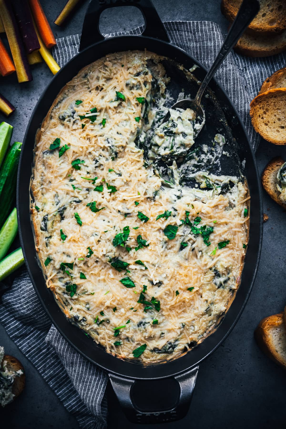 overhead view of vegan spinach artichoke dip in a skillet. 