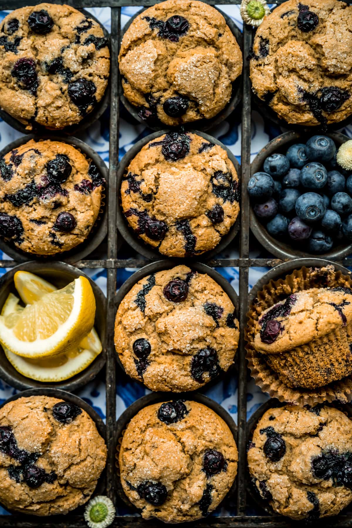 overhead view of vegan blueberry muffins in antique muffin tin. 