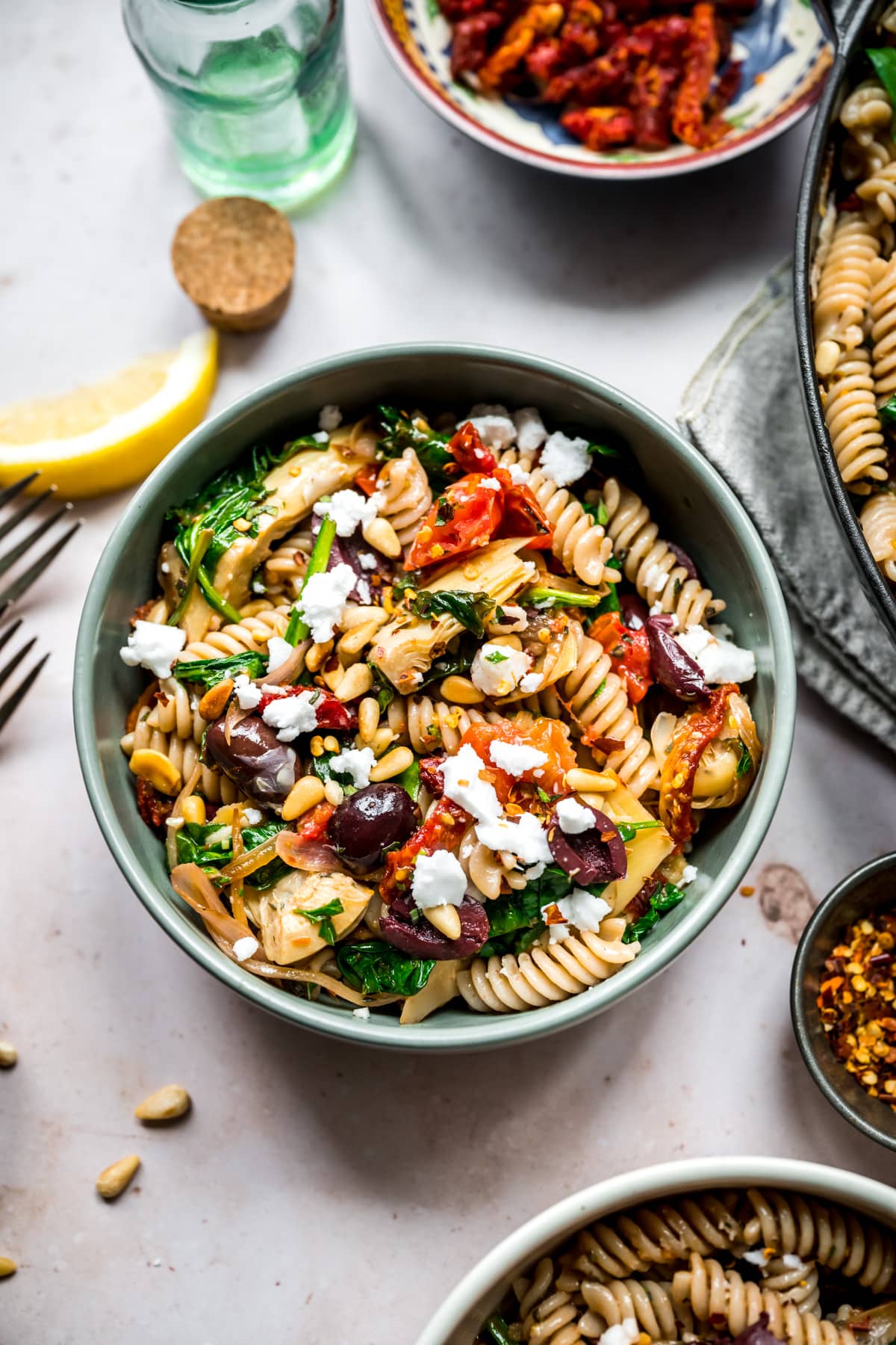 overhead view of vegan greek pasta in a blue bowl. 