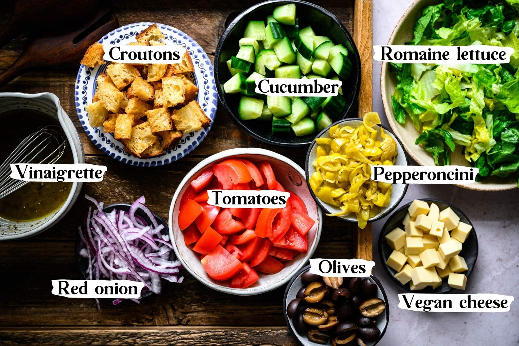 overhead view of ingredients for italian chopped salad in bowls. 