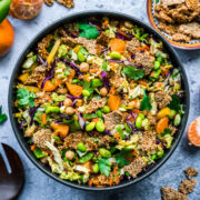 overhead view of vegan sesame chickpea salad in a large bowl with edamame, cabbage and sesame brittle.