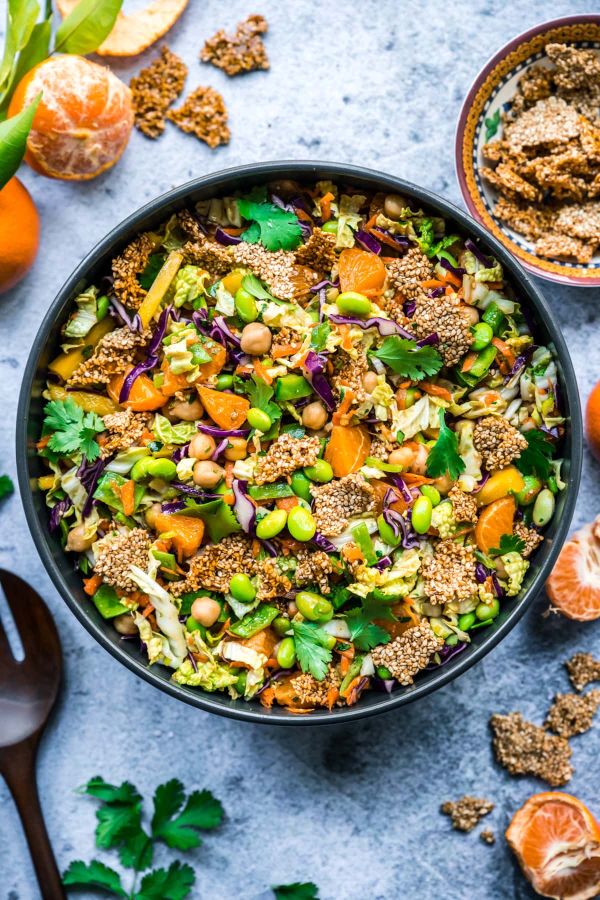 overhead view of vegan sesame chickpea salad in a large bowl with edamame, cabbage and sesame brittle. 