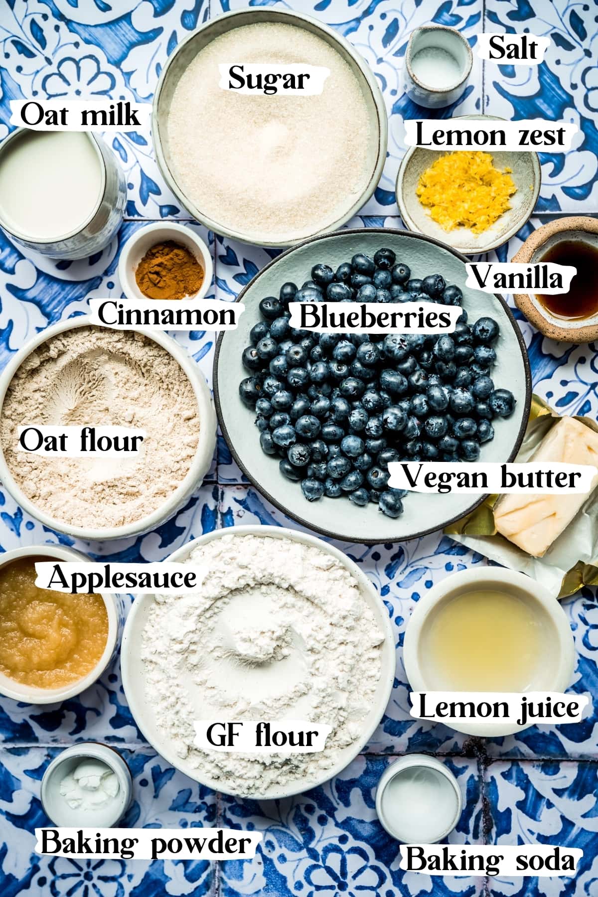 overhead view of ingredients for vegan blueberry muffins in small bowls. 