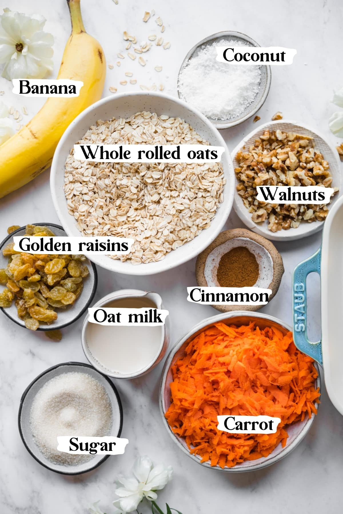 overhead view of ingredients for carrot cake oatmeal on marble surface. 