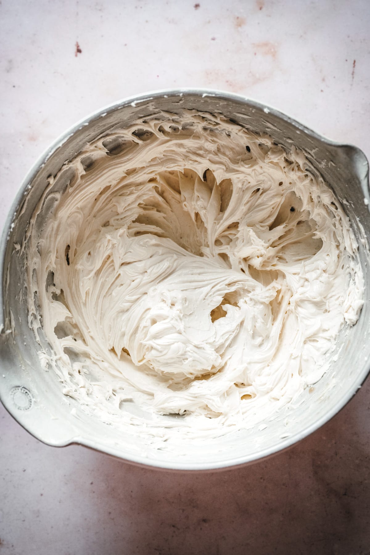 close up overhead view of vegan vanilla buttercream frosting in bowl. 