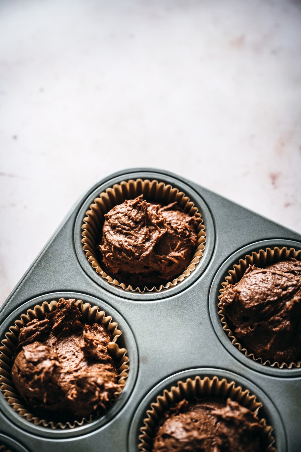 vegan chocolate cupcake batter in muffin tins. 