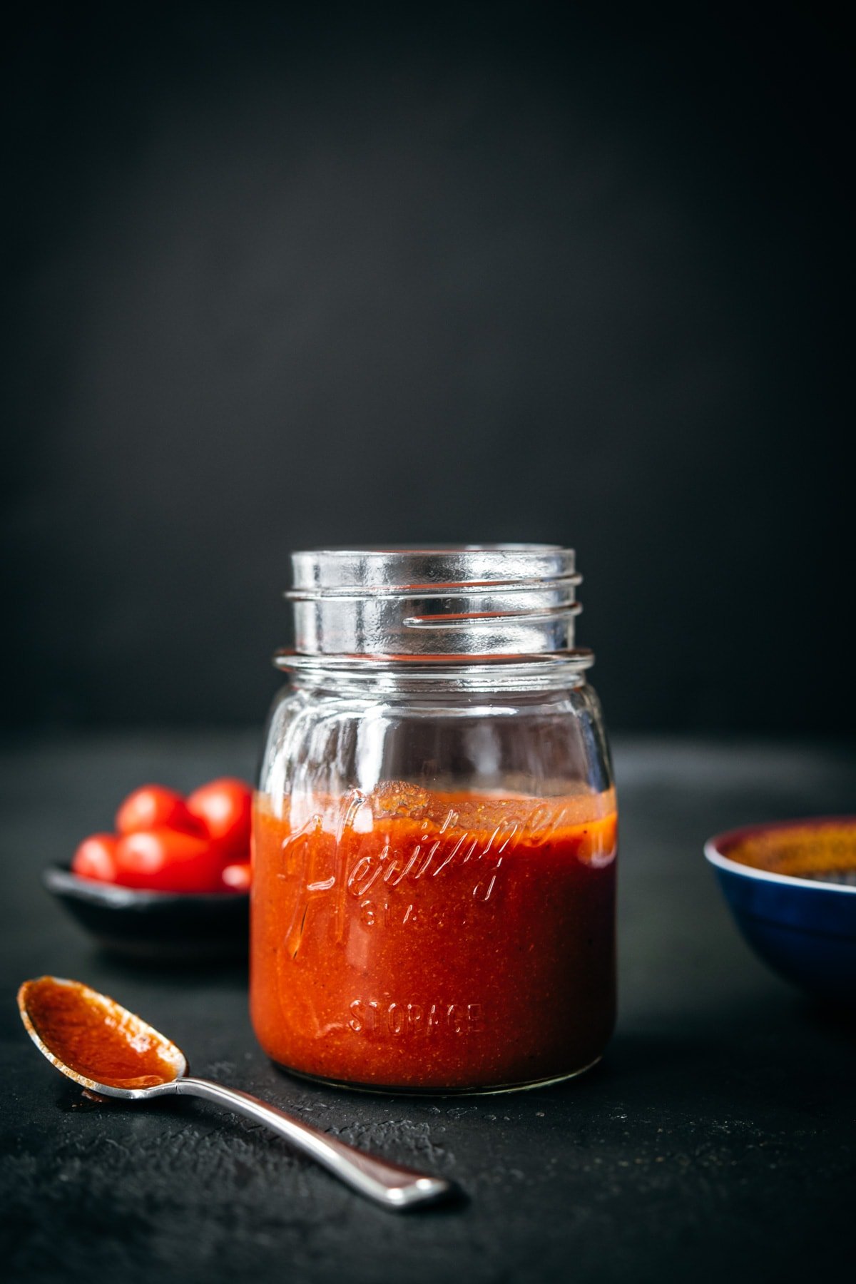 close up side view of homemade taco sauce in glass mason jar. 