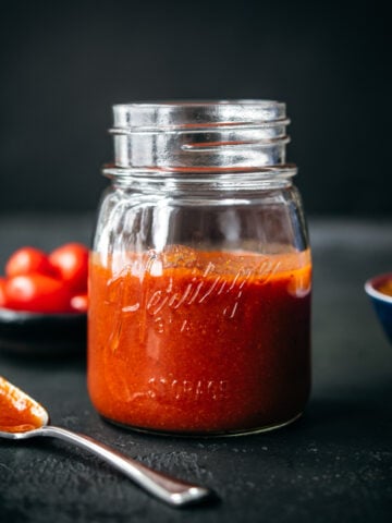 close up side view of homemade taco sauce in glass mason jar.