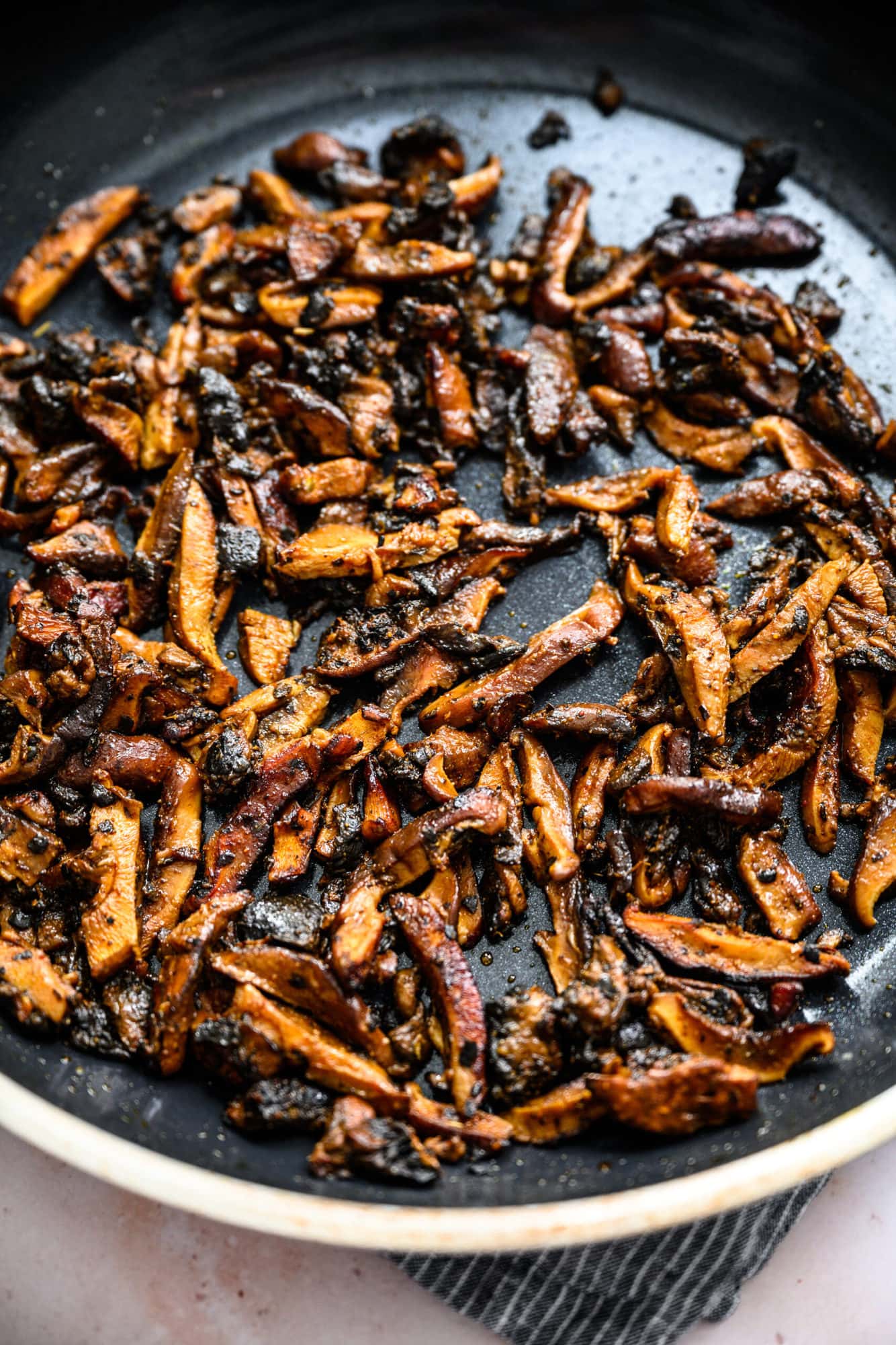 close up view of mushrooms in pan cooked in shawarma marinade. 