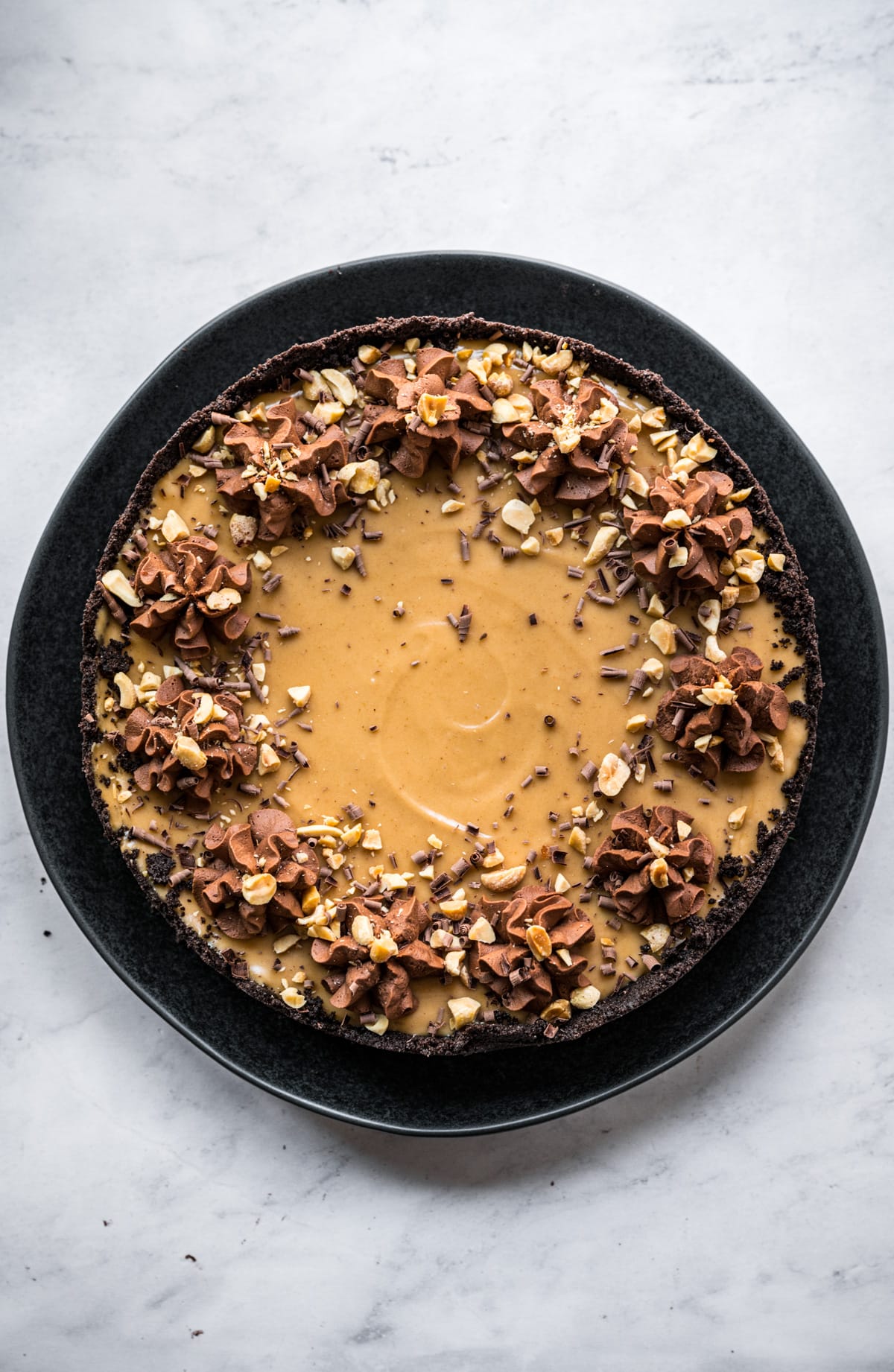 overhead view of vegan peanut butter pie with chocolate frosting on top. 