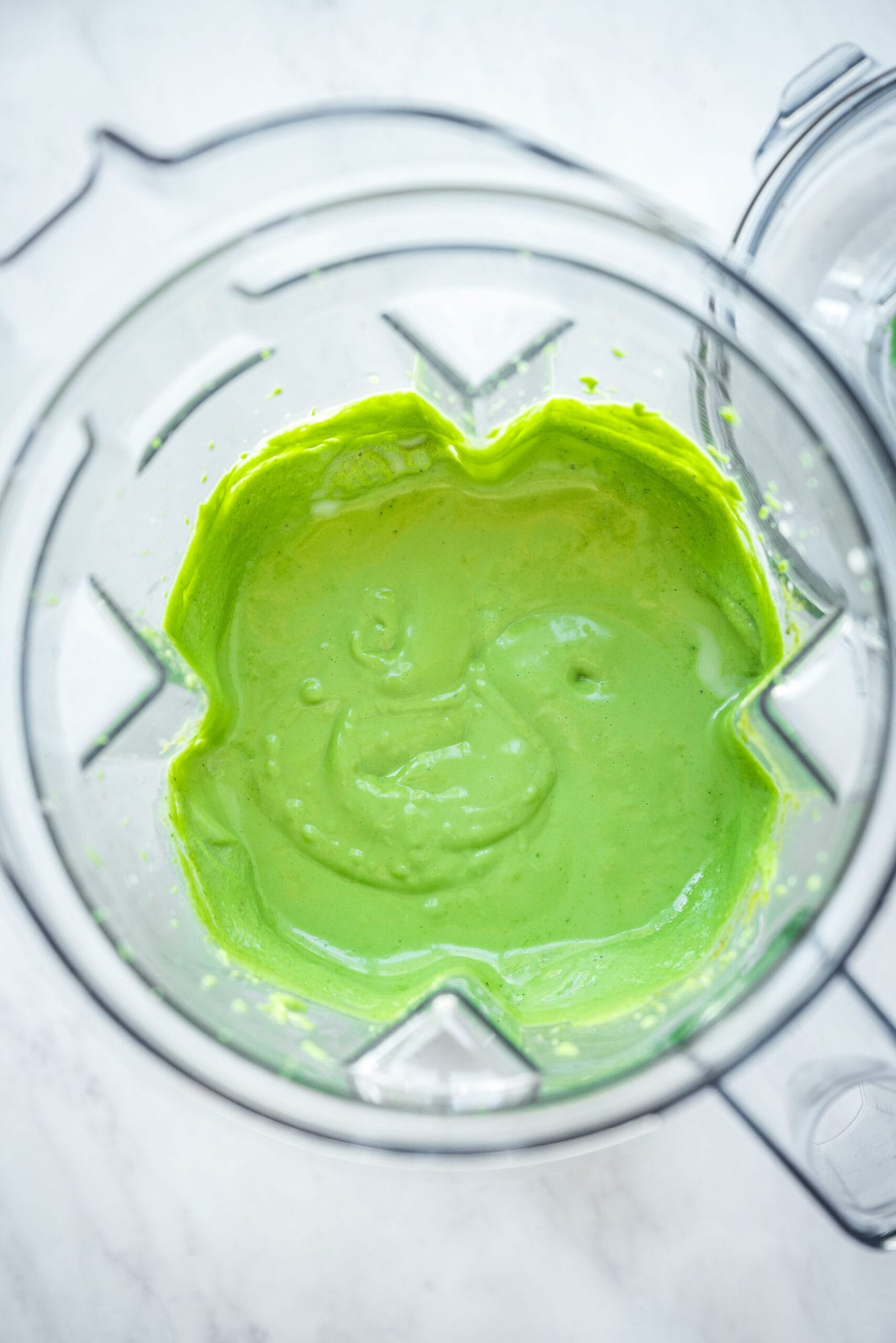 overhead view of green vegan shamrock shake in blender.