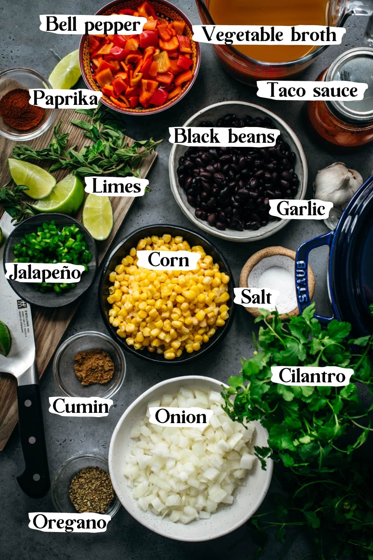 overhead view of ingredients for vegan tortilla soup in small bowls. 