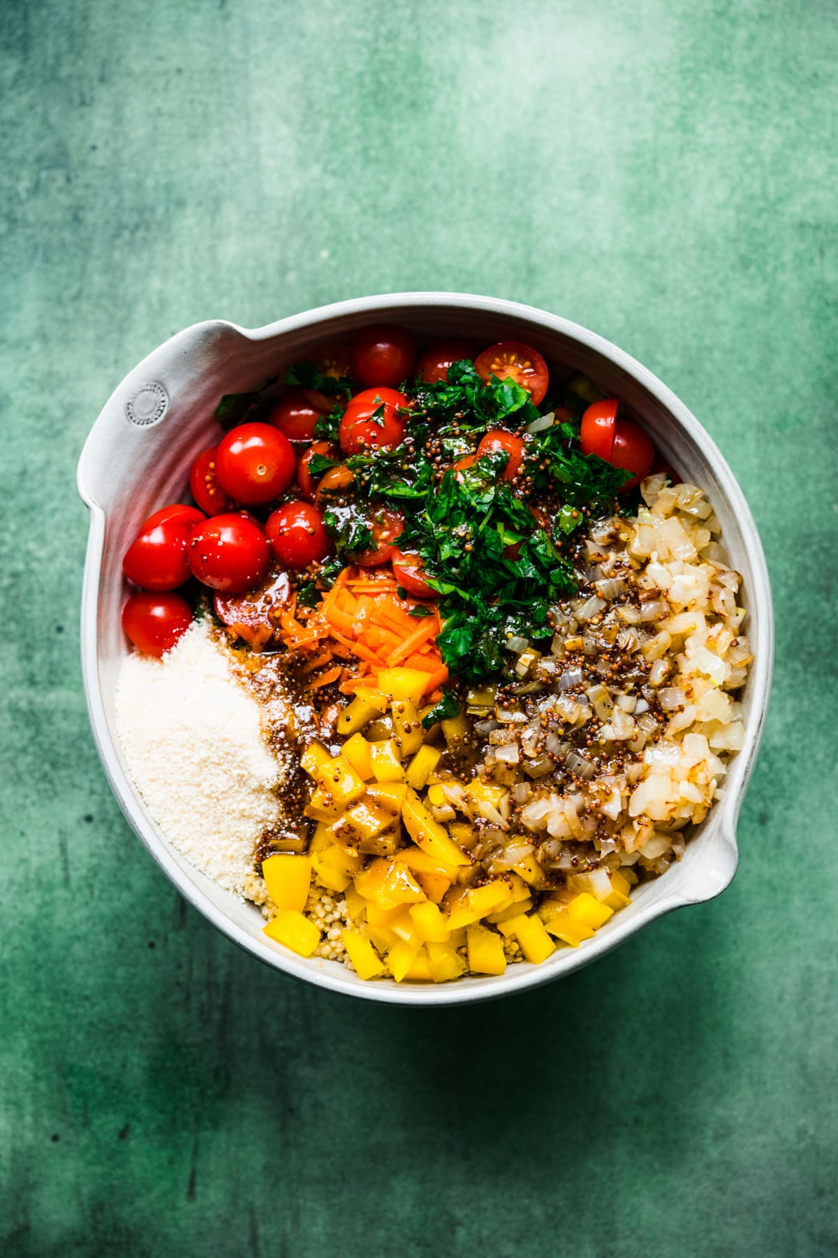 overhead view of all ingredients for vegan quinoa chickpea salad in mixing bowl. 