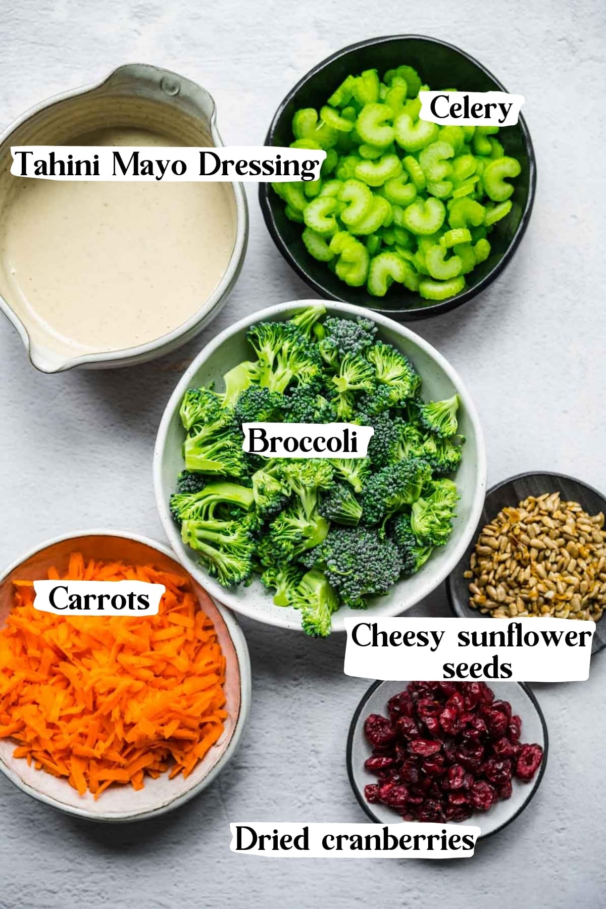 overhead view of ingredients for vegan broccoli salad in small prep bowls. 