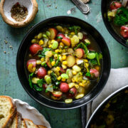 overhead view of bowl of vegan lima bean soup with potatoes and corn.