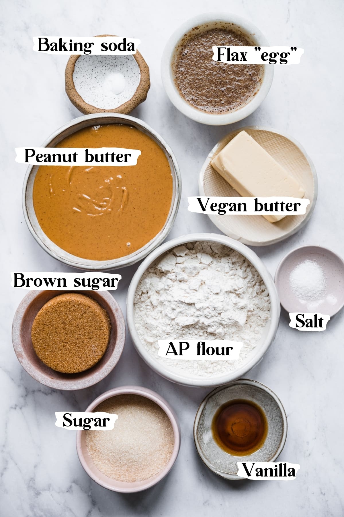 overhead view of ingredients for vegan peanut butter cookies in small prep bowls. 