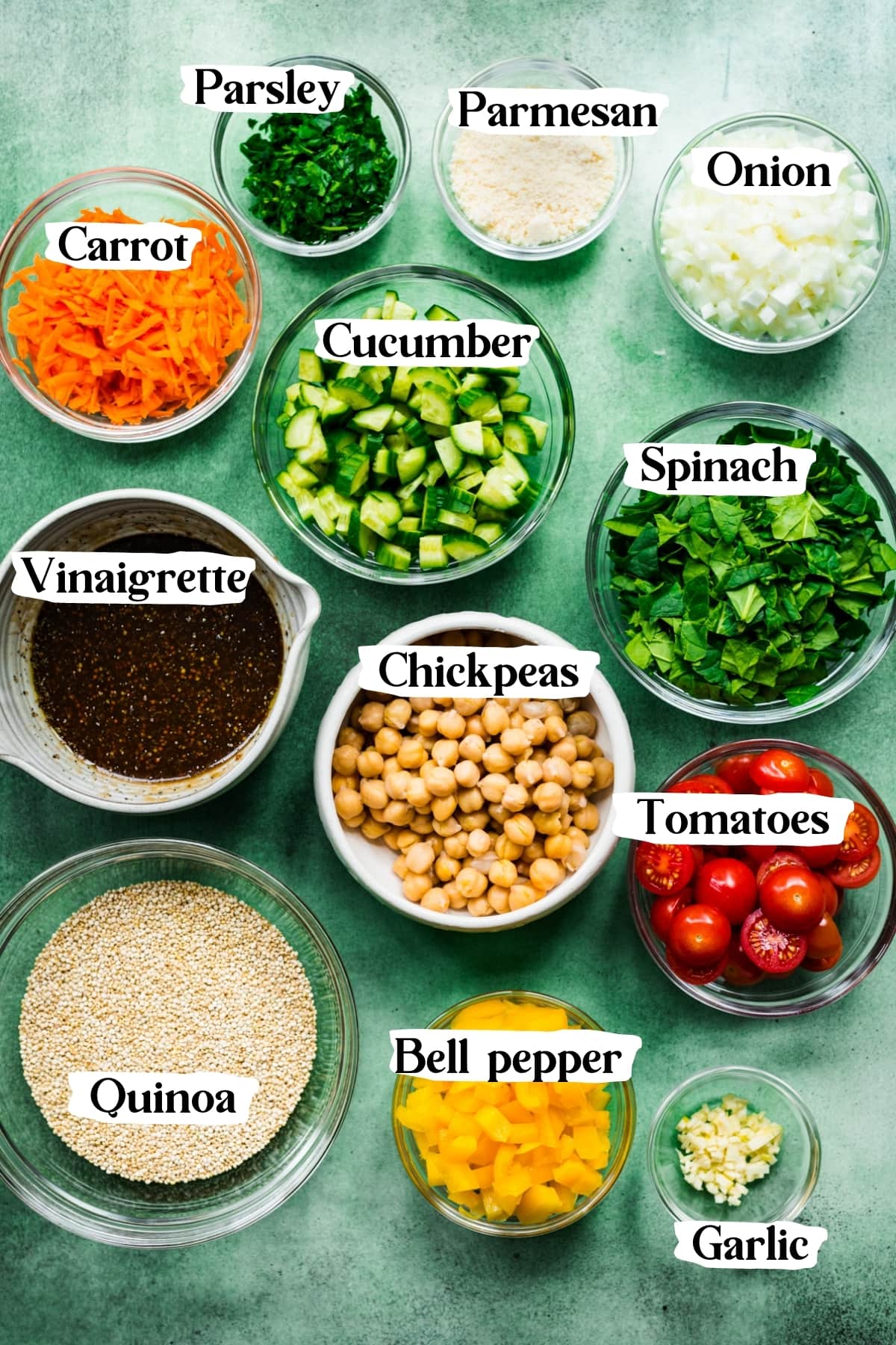 overhead view of ingredients for vegan quinoa chickpea salad in small bowls. 