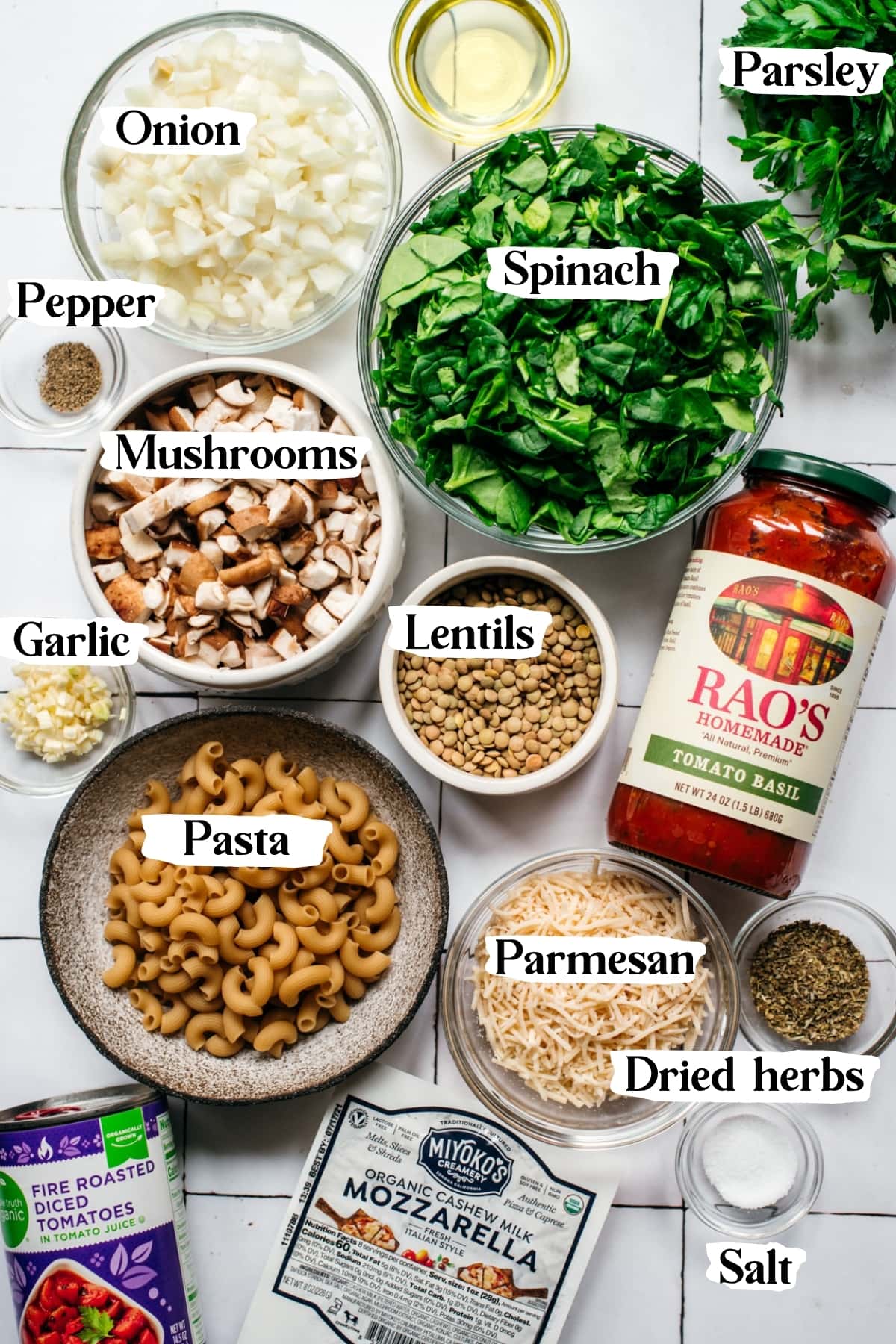 overhead view of ingredients for vegan pasta bake in small bowls. 