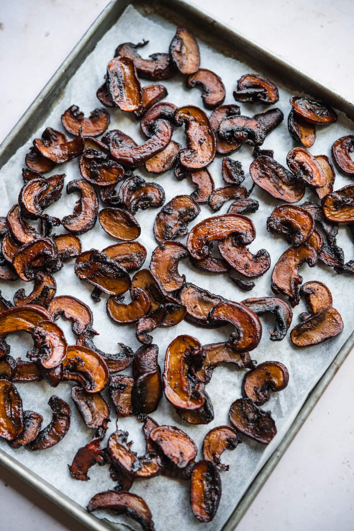 close up view of mushroom bacon on a sheet pan. 