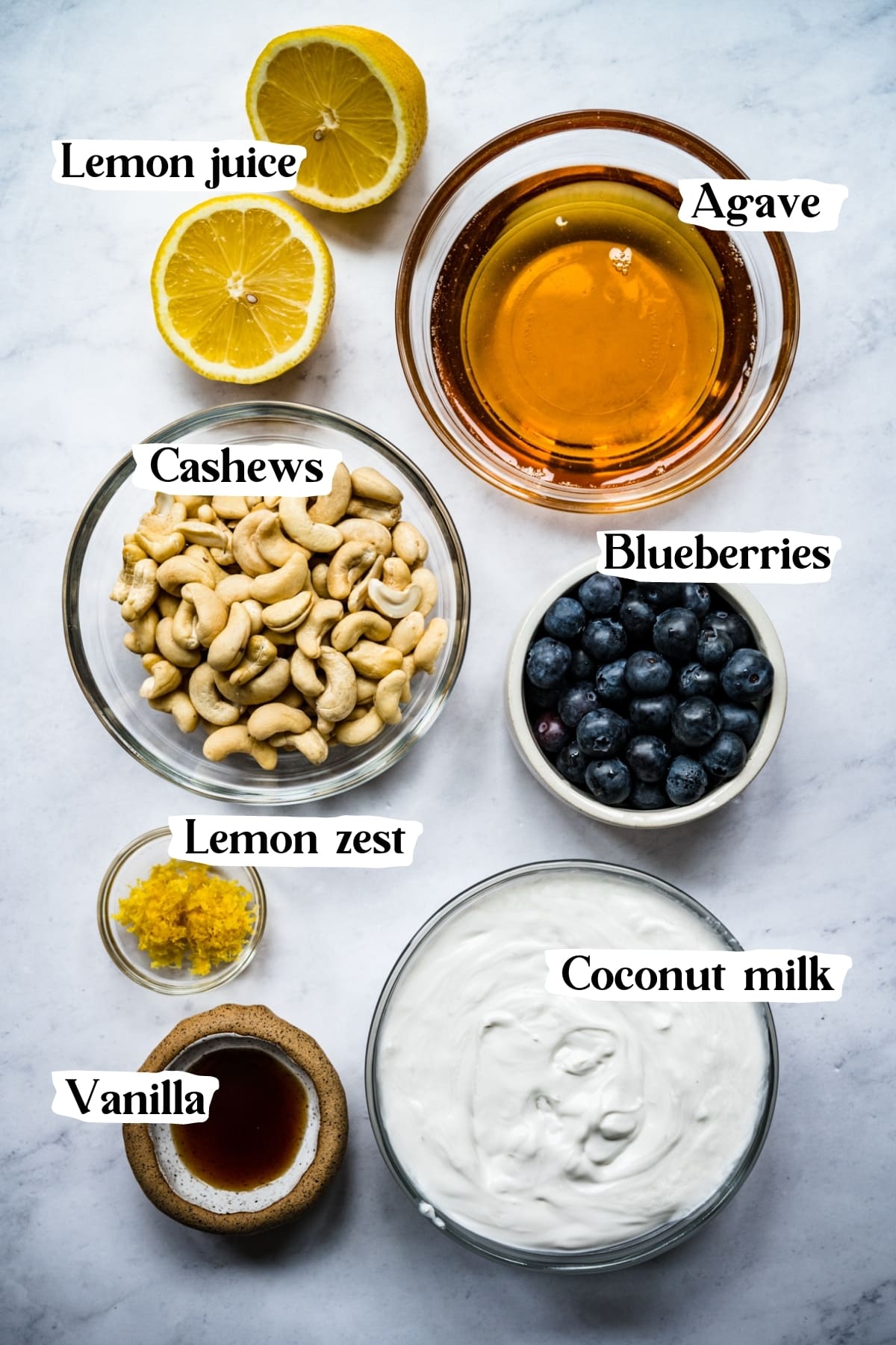 overhead view of ingredients for vegan blueberry lemon ice cream in small prep bowls. 