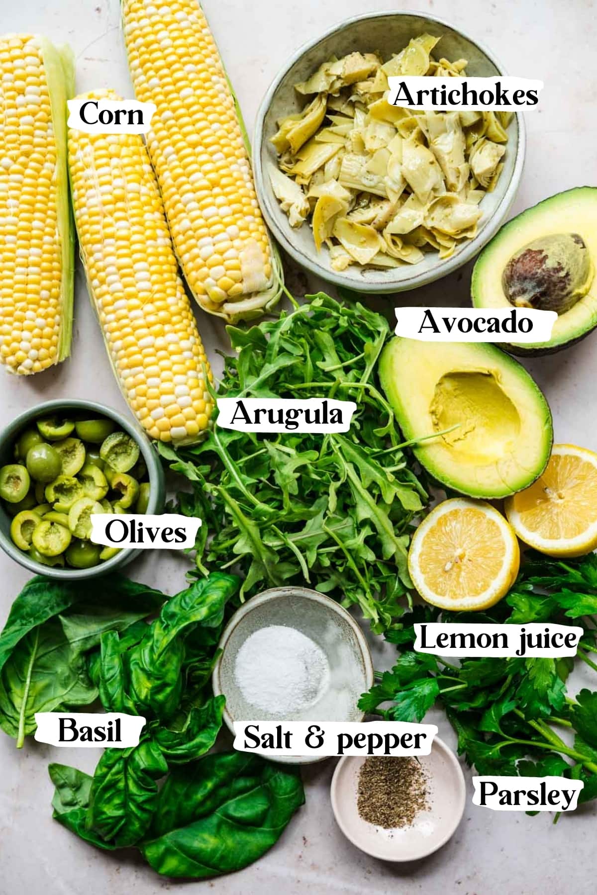 overhead view of ingredients for corn avocado arugula salad. 