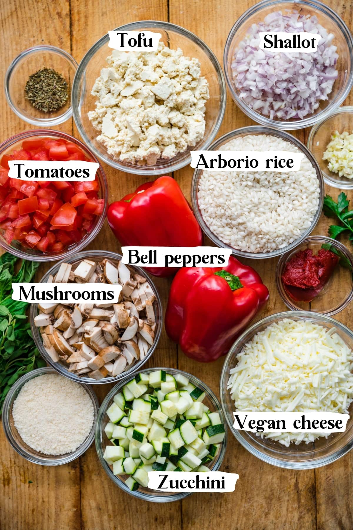 overhead view of ingredients for vegan stuffed peppers with tofu risotto filling in prep bowls. 