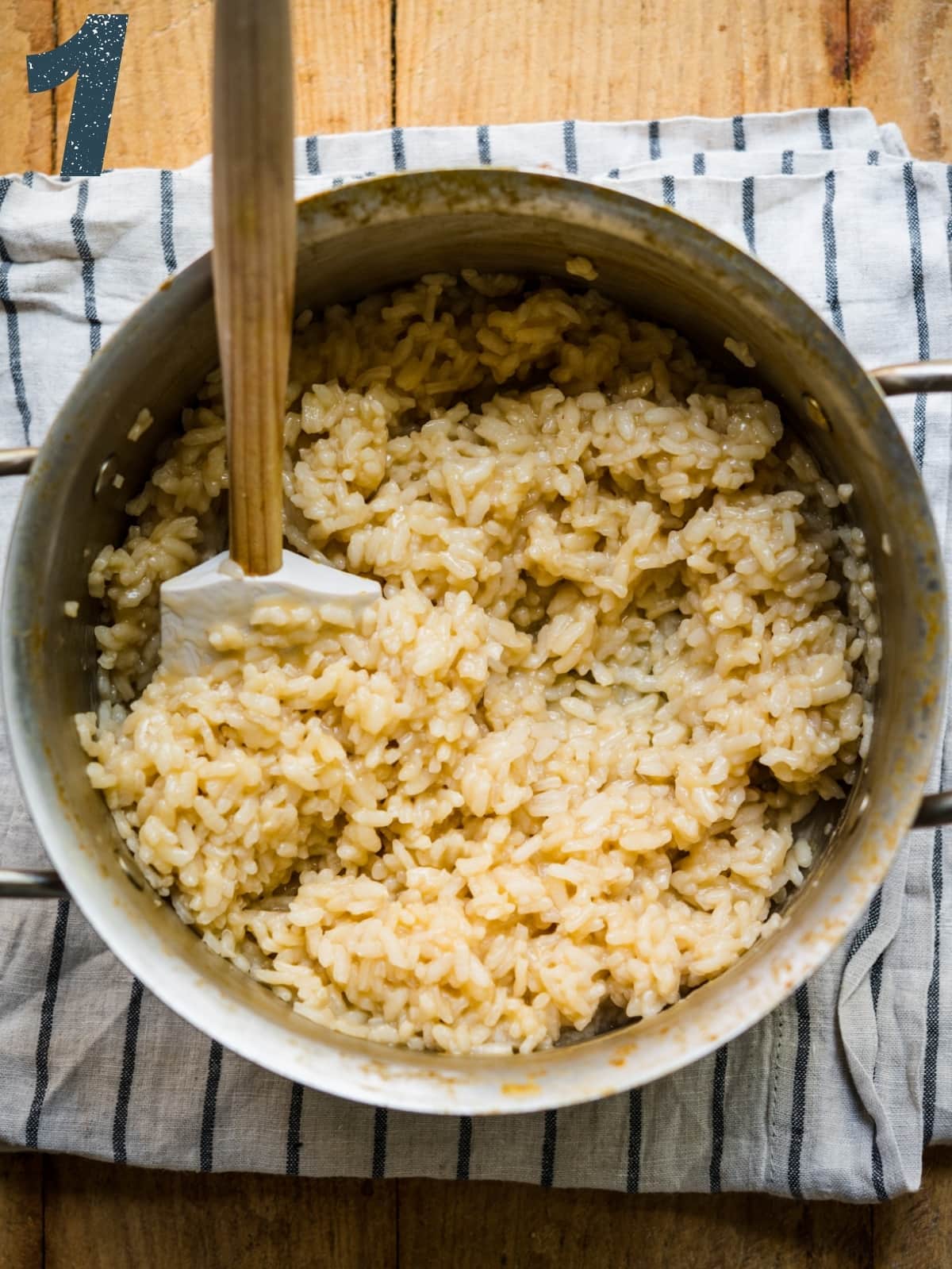 overhead view of cooked risotto rice in small pot. 