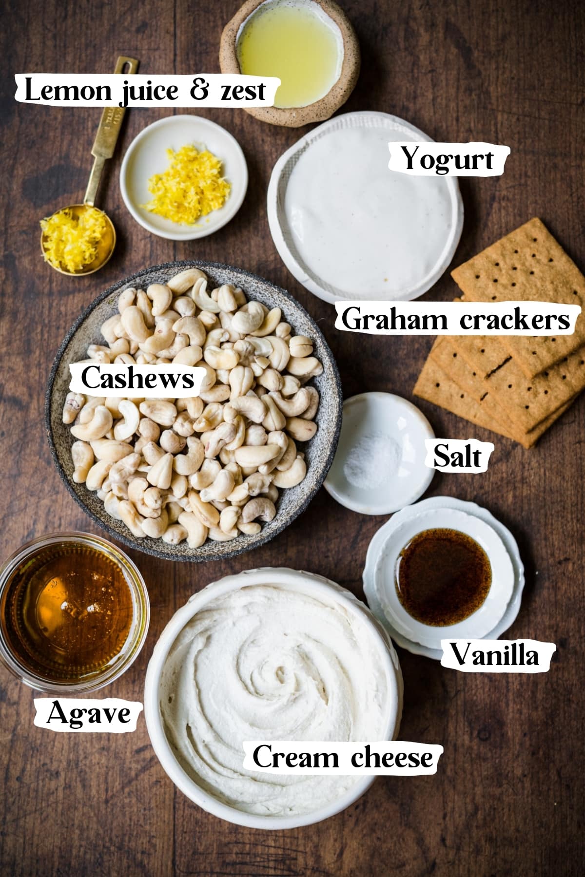 overhead view of ingredients for no bake vegan cheesecake, including cashews, cream cheese and graham crackers. 