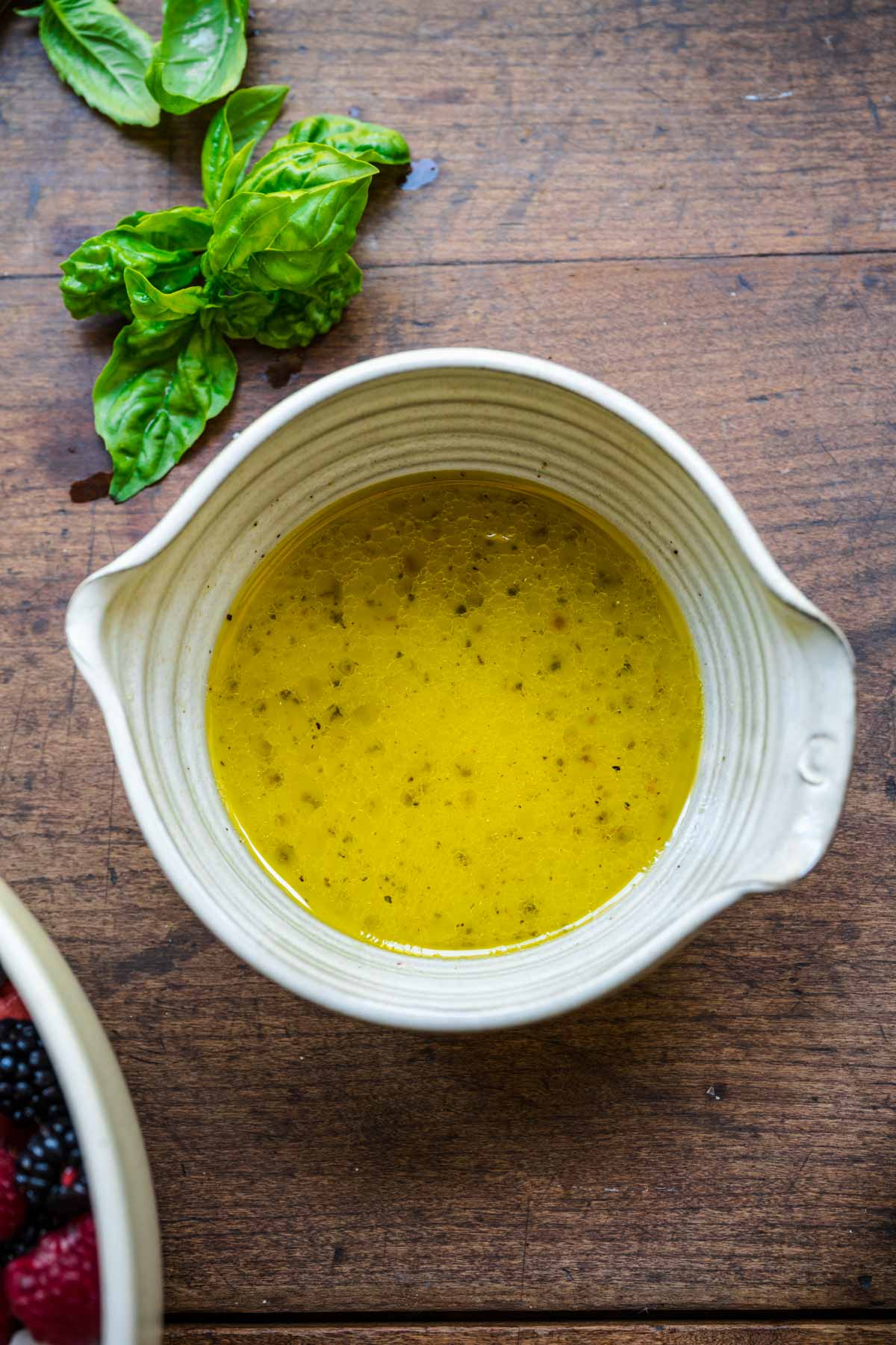 overhead view of lemon champagne vinaigrette in small mixing bowl. 