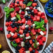 close up overhead view of red white and blue fruit salad on a platter.