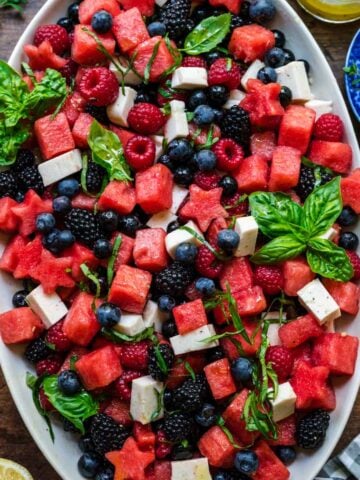 close up overhead view of red white and blue fruit salad on a platter.