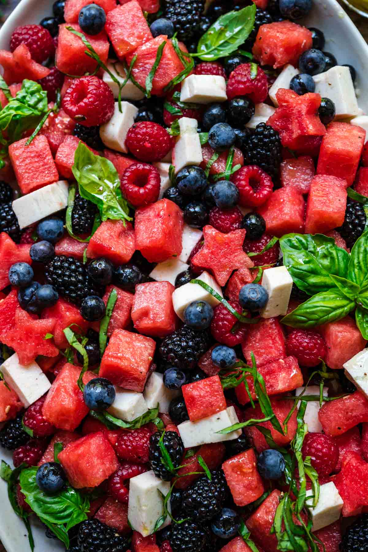 close up overhead view of red white and blue fruit salad on a platter. 