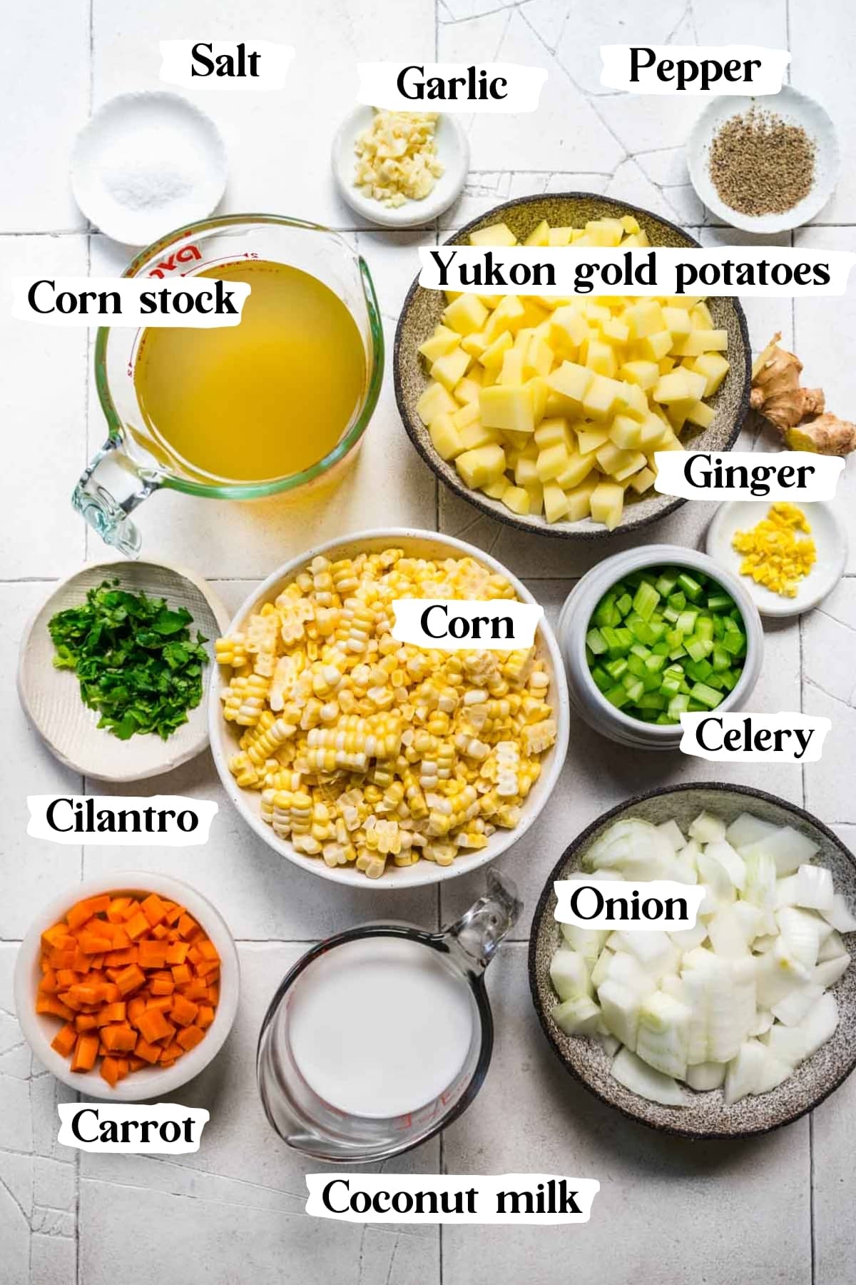 overhead view of ingredients for vegan corn chowder in small prep bowls. 