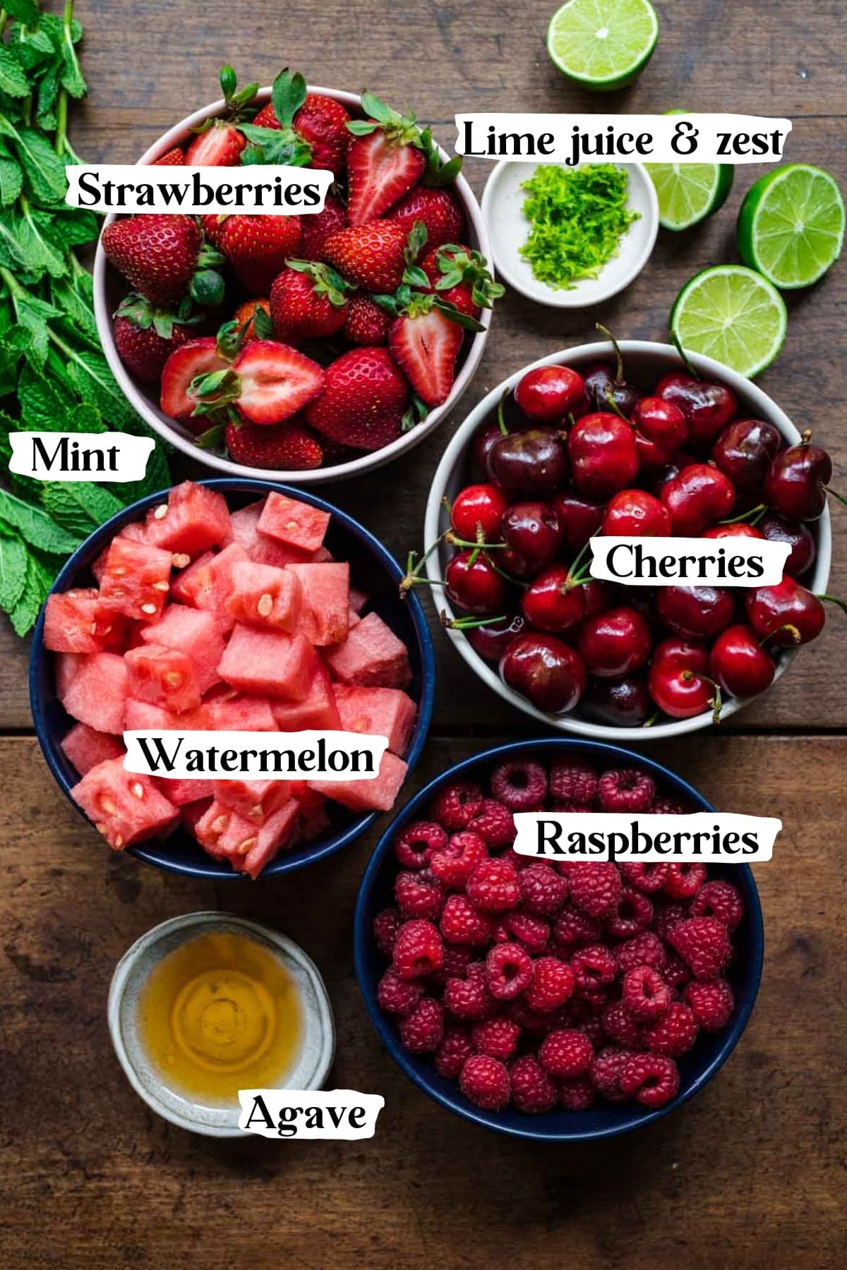 overhead view of ingredients for watermelon berry salad in prep bowls. 