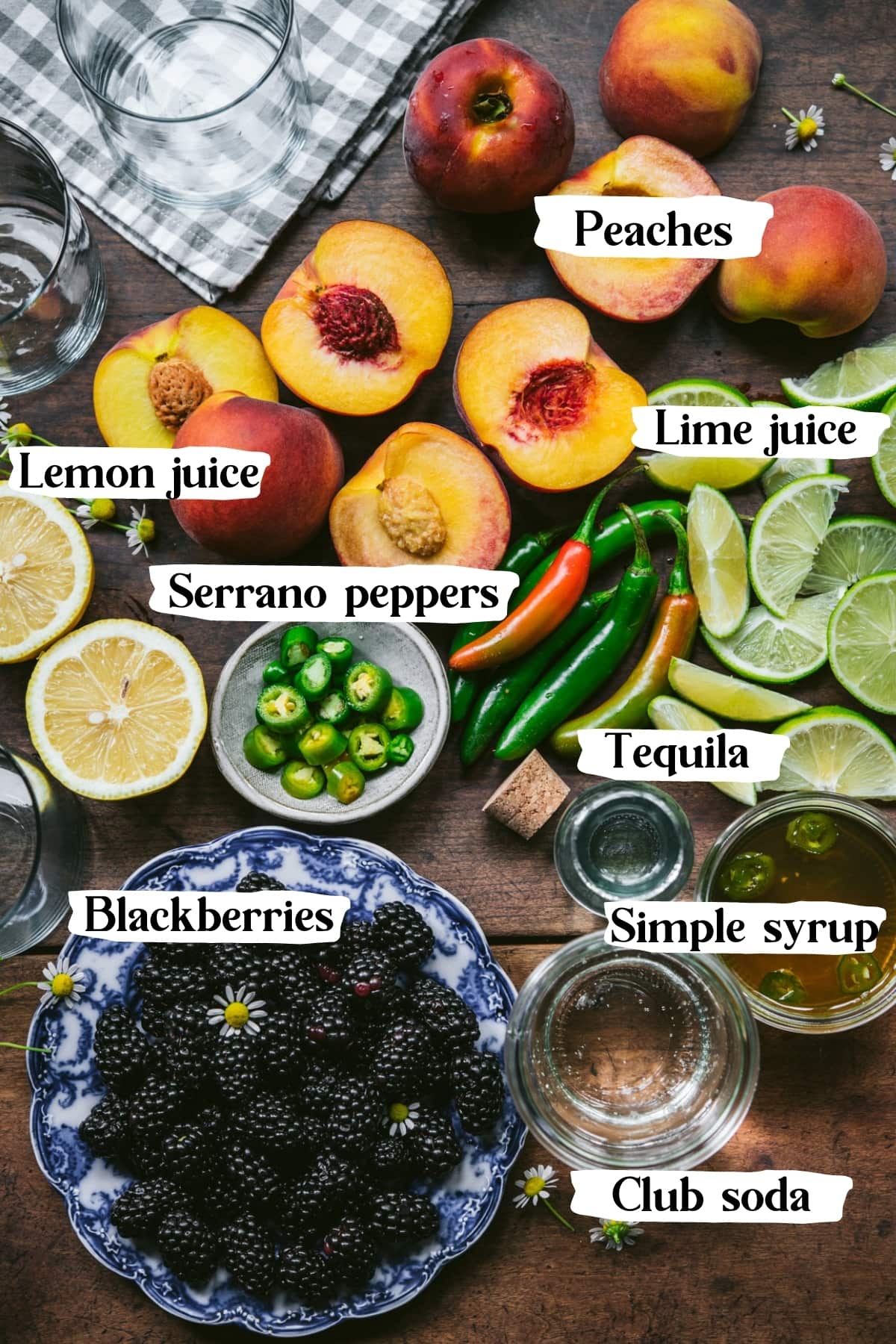 overhead view of ingredients for blackberry peach serrano cocktail. 