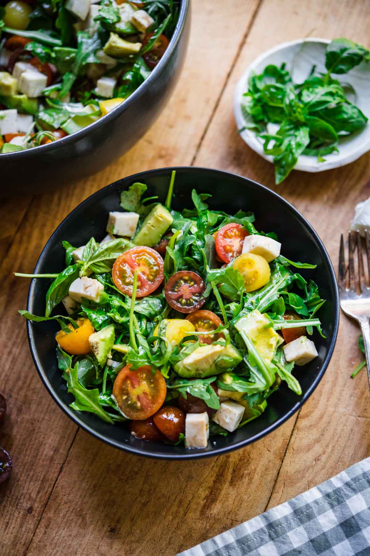 Arugula caprese salad in a small bowl. 