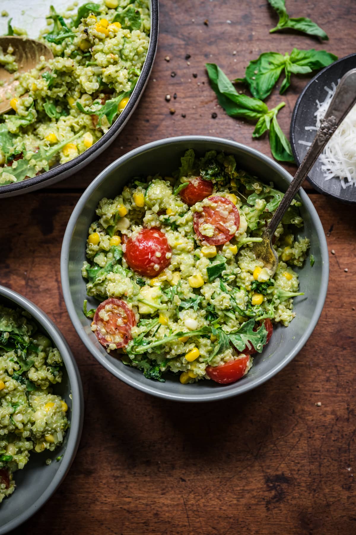 Green goddess salad in bowl. Full of quinoa, corn, and cherry tomatoes.