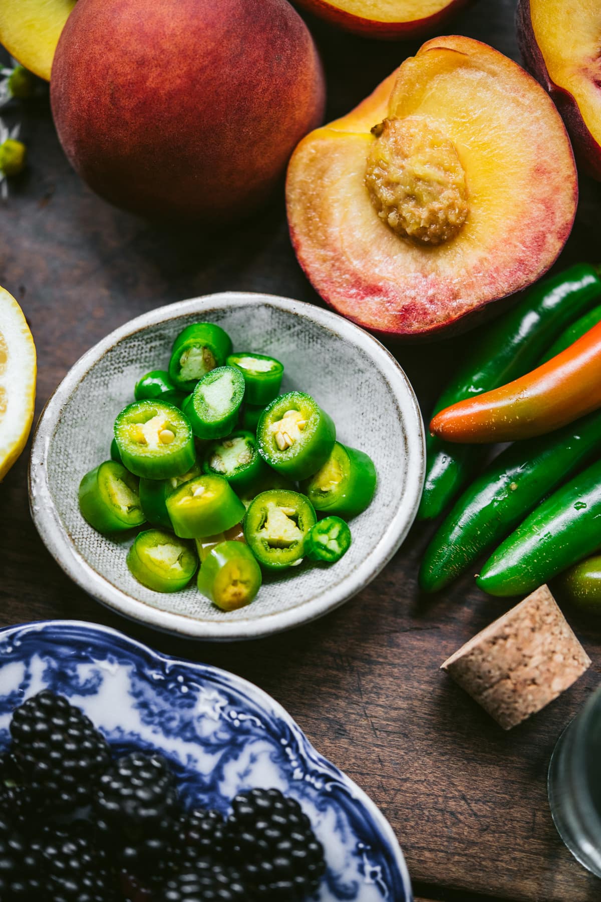 close up view of sliced serrano peppers in small bowl. 