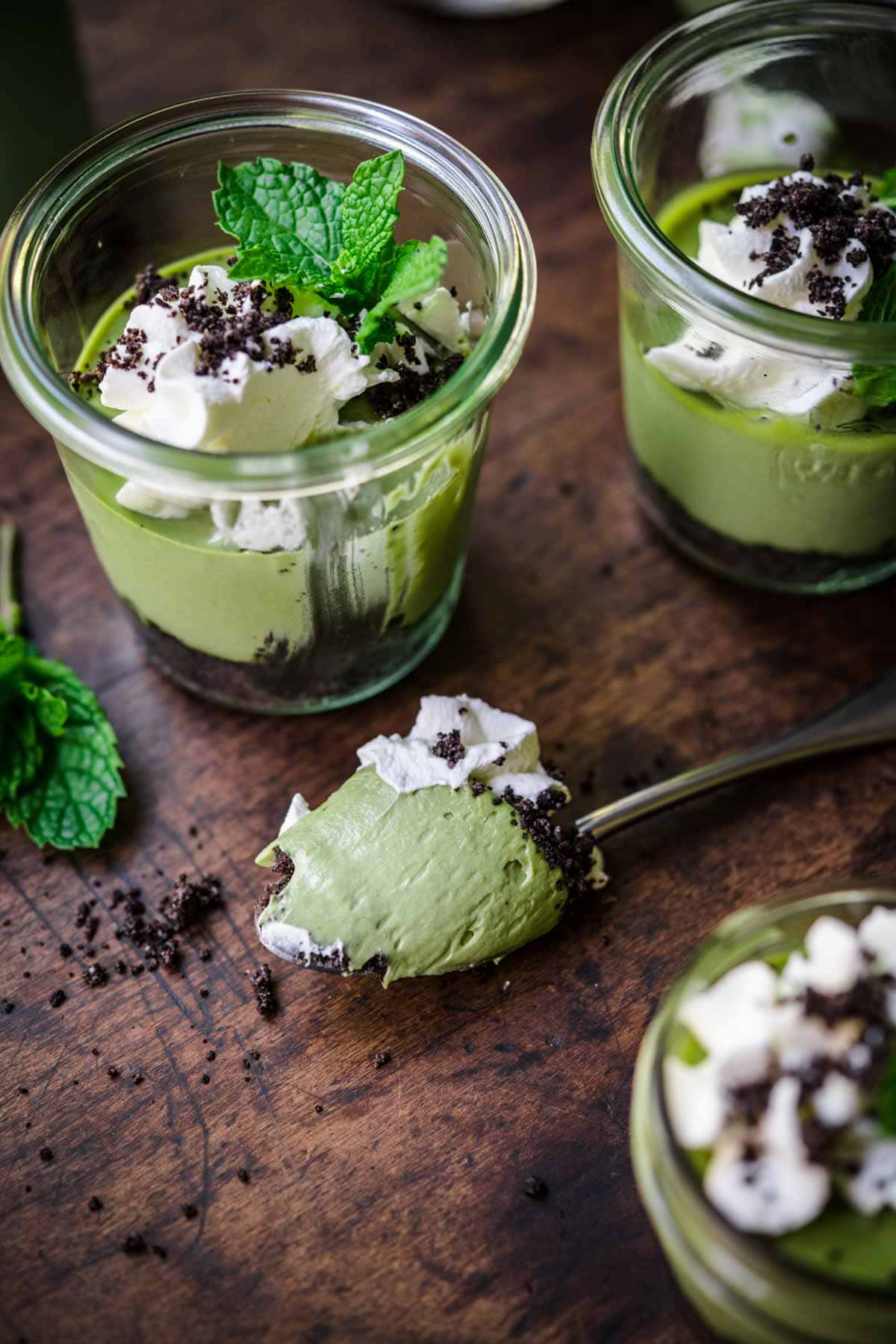 Overhead view of mini cheesecake in a jar with a spoonful taken out.