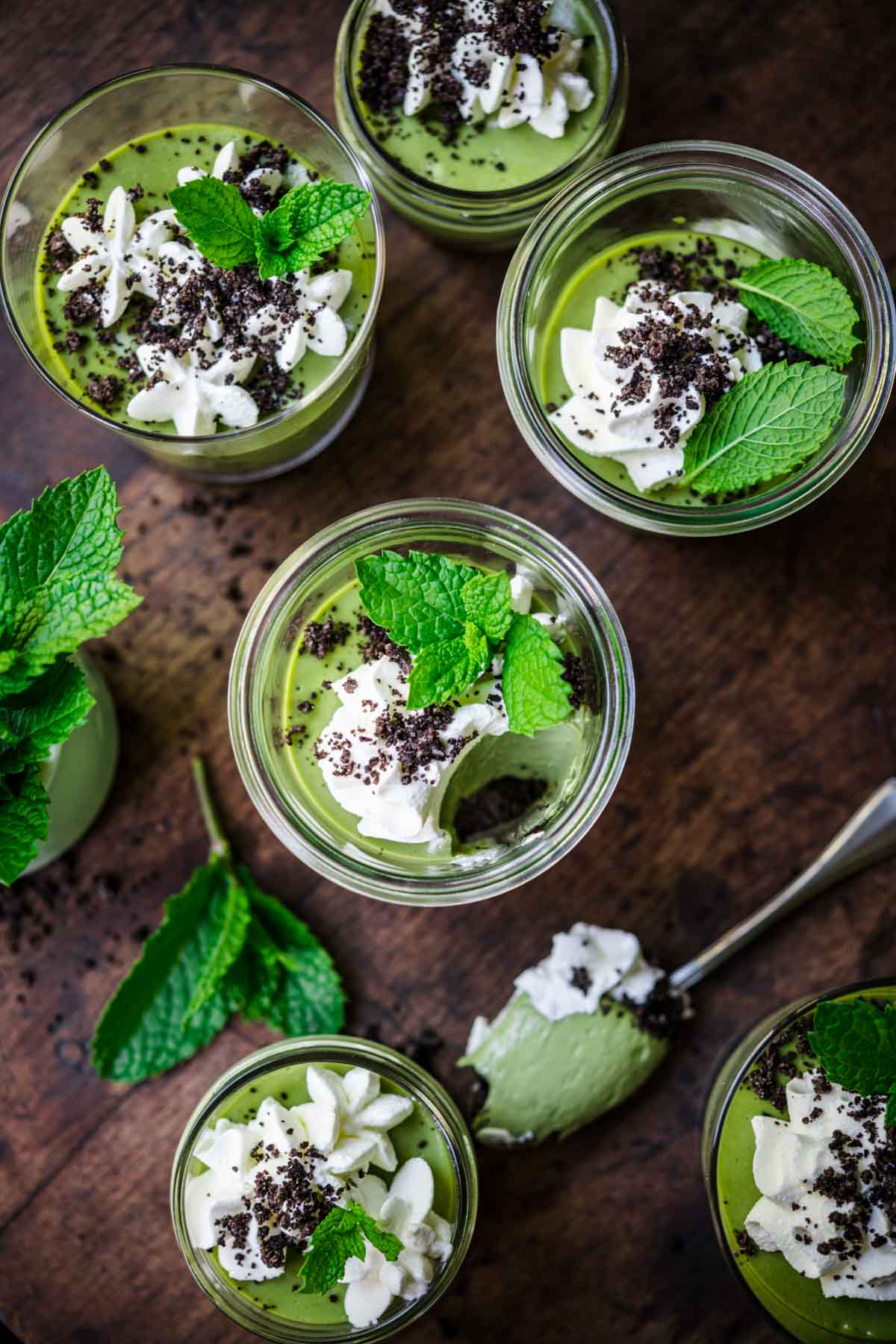 overhead view of vegan mint chocolate cheesecakes in jars. 