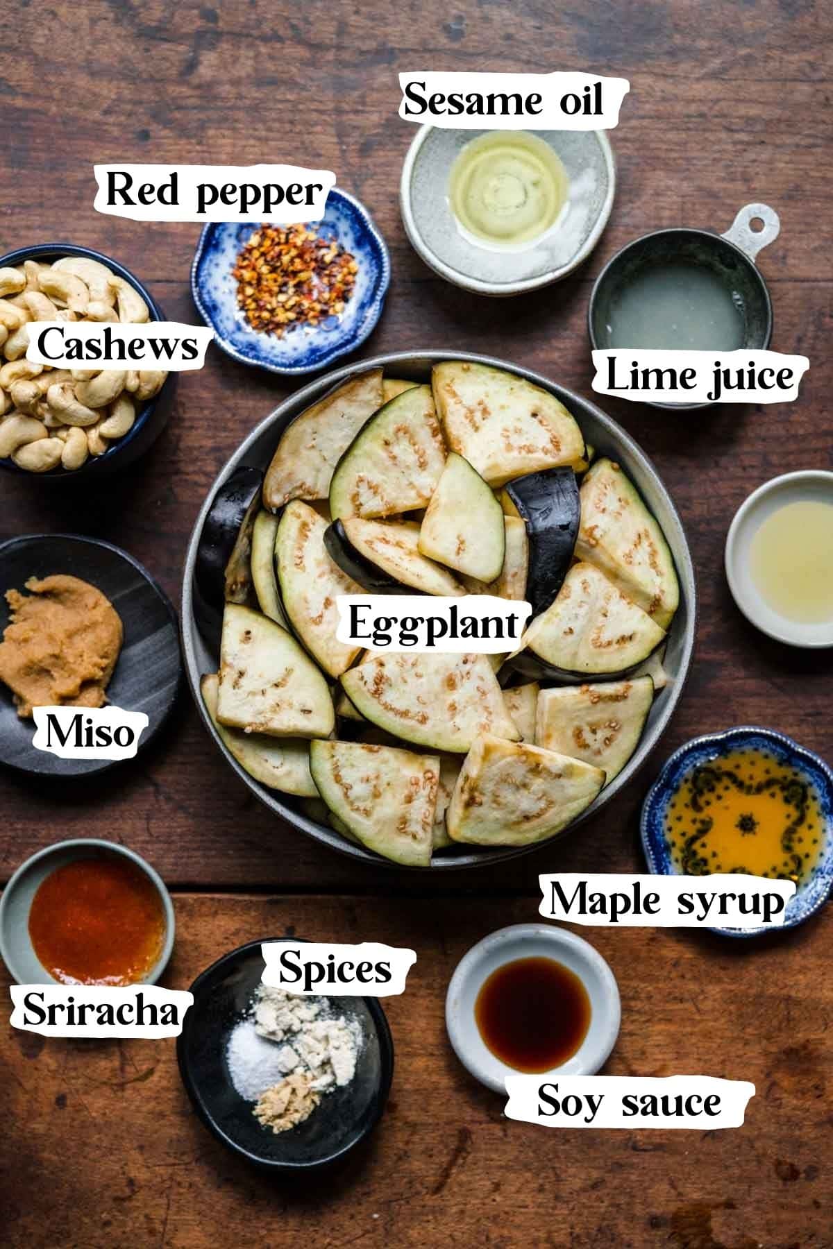 Overhead view of miso eggplant ingredients, including eggplant, miso, sesame oil, and lime juice.