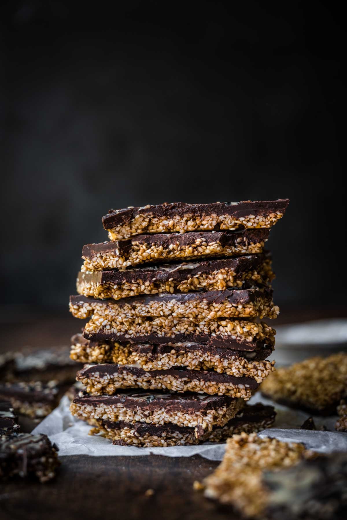 Front view of stacked pieces of broken up sesame chocolate bark