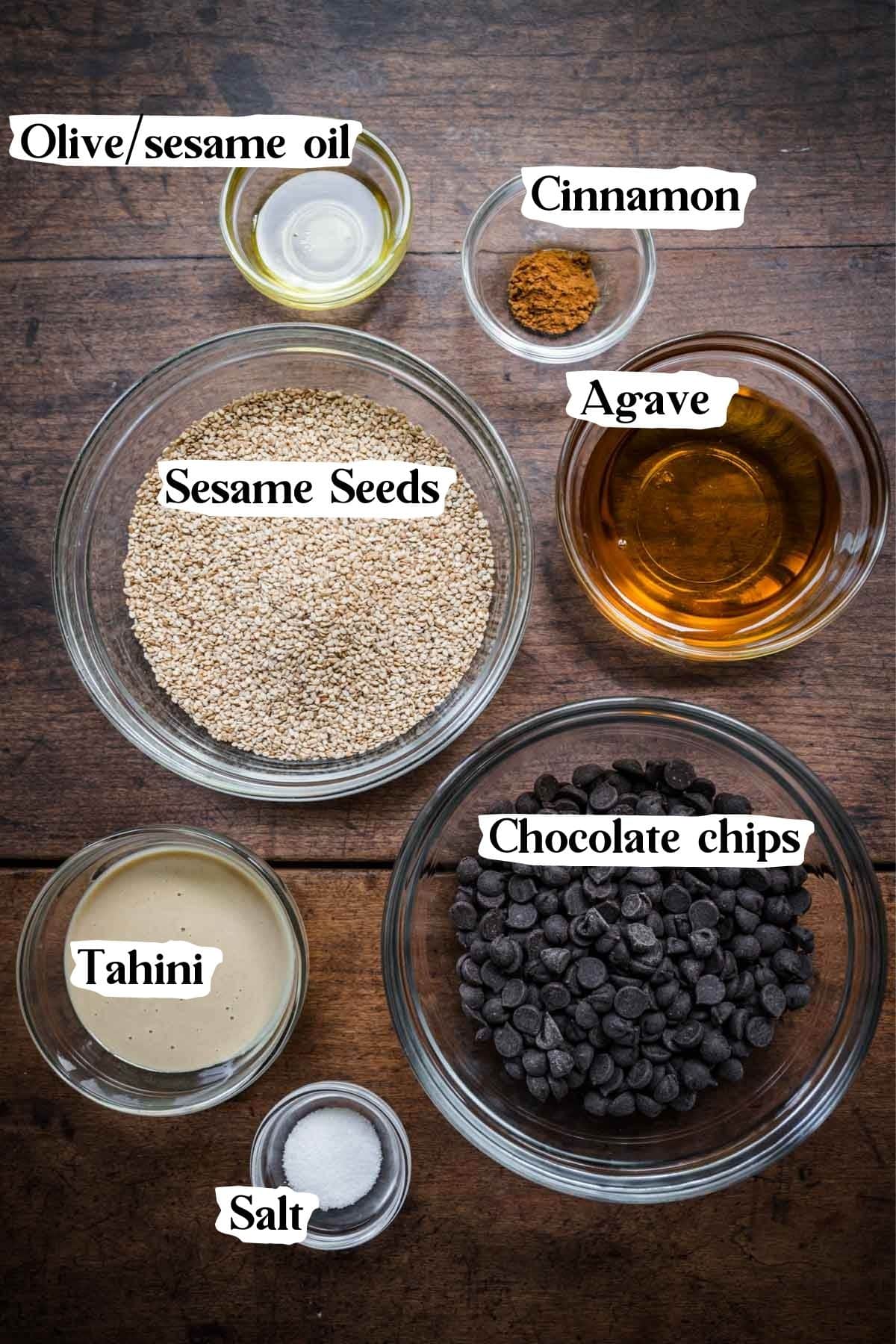 overhead view of ingredients for sesame chocolate bark in small bowls. 