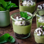 Front view of mini green cheesecake in a glass jar.