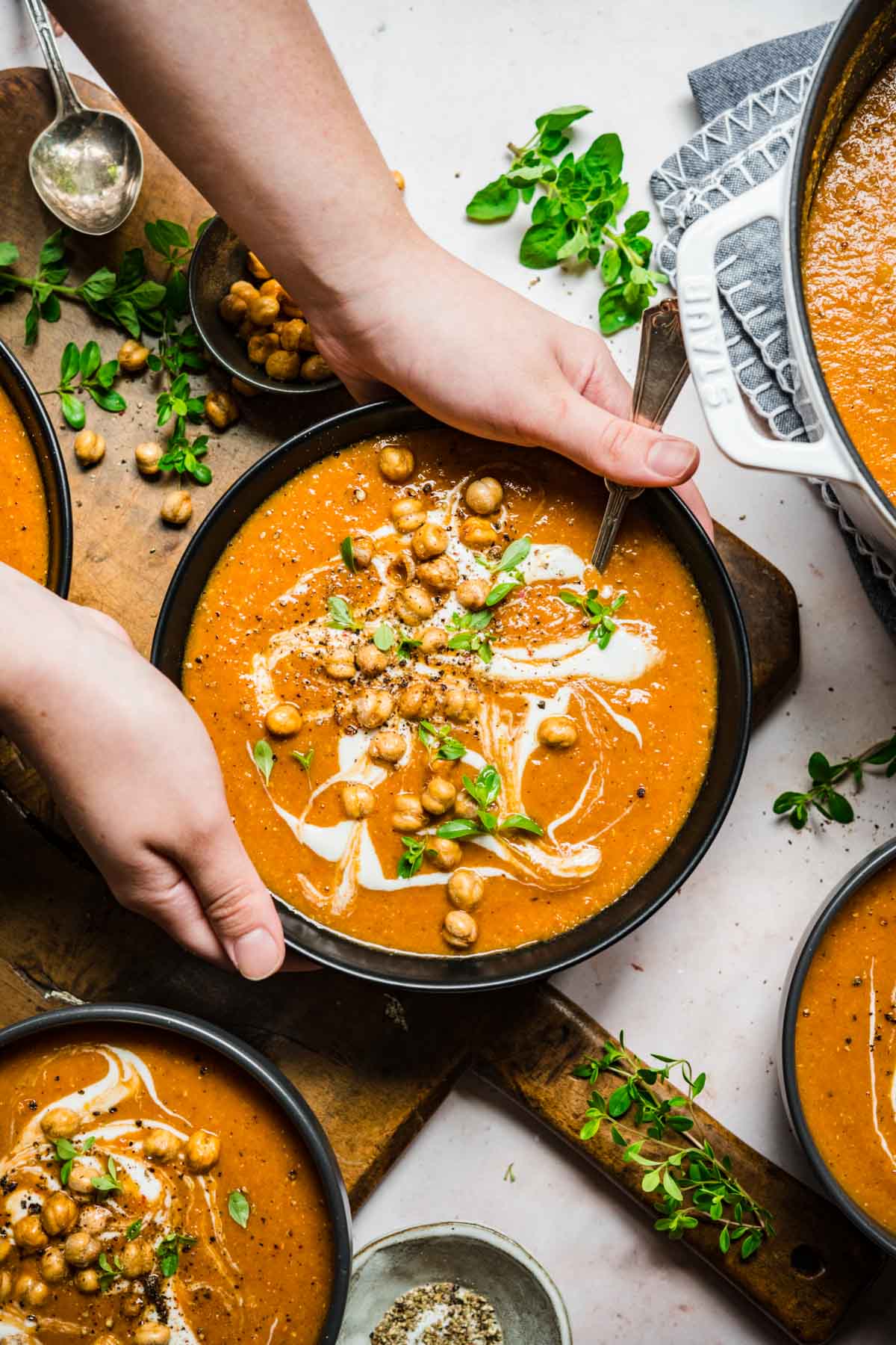 Overhead view of someone grabbing a bowl of lentil soup.