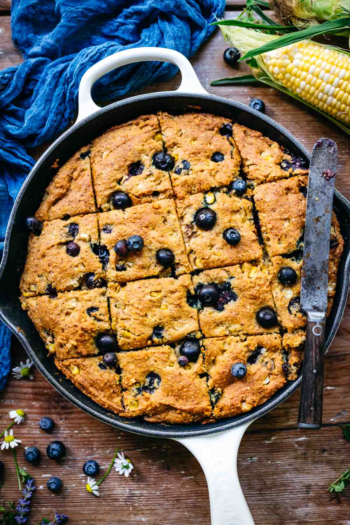 Overhead view of blueberry cornbread in a skillet.