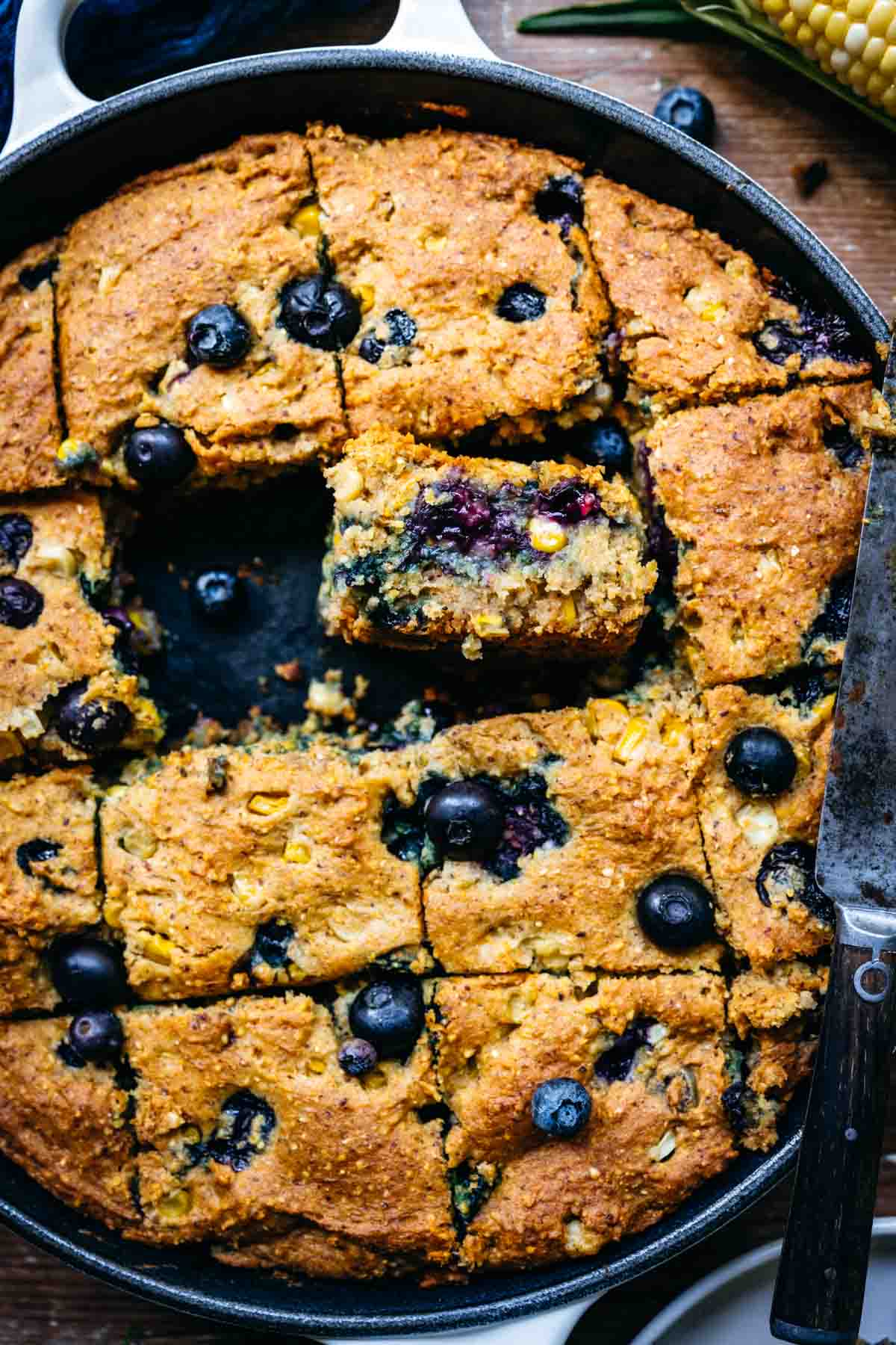 Close up overhead view of blueberry cornbread in a skillet.